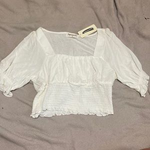 Women’s cropped blouse. Kind of have a puff sleeve.